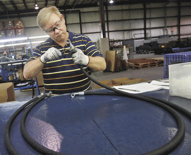 Brenna Norman/The Hawk Eye Jeff Furnald of West Burlington measures and checks a hydraulic hose March 5 at Alfagomma America's plant, 3520 West Ave., in Burlington. The factory sizes and assembles high-pressure hydraulic hoses.
