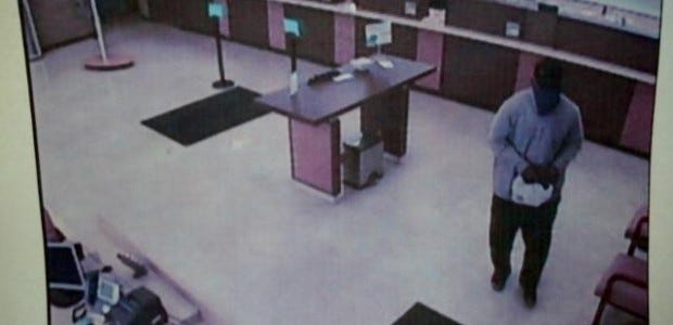 Surveillance video from Huntington Bank in Ambridge shows a man police identified as Keith Lamark Fisher walking away from tellers with a bag of money.  Fisher pleaded guilty last year to charges stemming from the bank robbery and was sentenced on March 7 to serve eight years in prison.