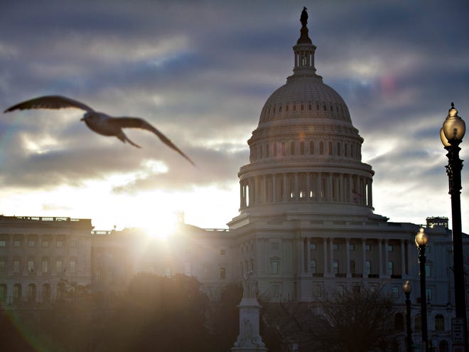 The sun breaks through clouds over the U.S. Capitol in Washington. Daylight-saving time begins at 2 a.m. Sunday, March 10, 2013, when clocks officially move ahead an hour.