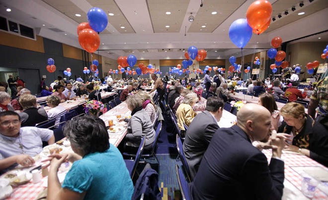 Attendees sit and eat cornbread, beans and sausage during the 24th annual Mayor's Beans and Cornbread Luncheon at the Lubbock Memorial Civic Center on Friday. Proceeds from the luncheon will go to the Hospice of Lubbock. (Scott MacWatters for the Lubbock Avalanche-Journal)