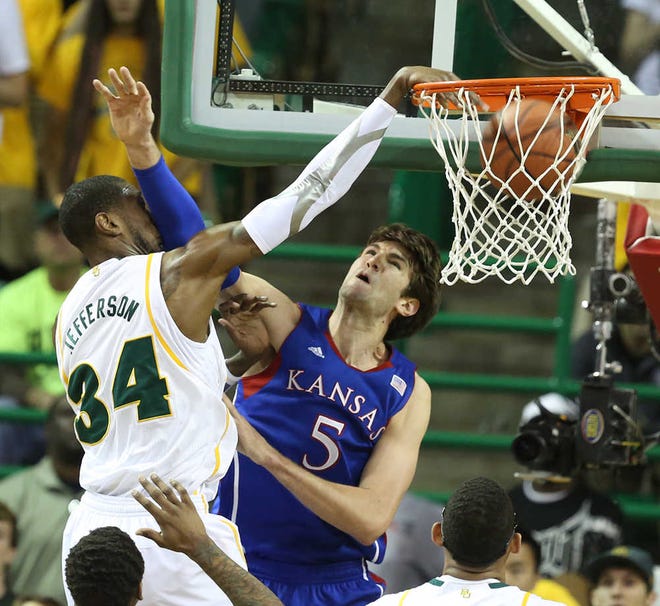Baylor's Cory Jefferson (34), left, dunks over Kansas Jeff Withey (5) in the first half of Saturday's upset win by the Bears in Waco.