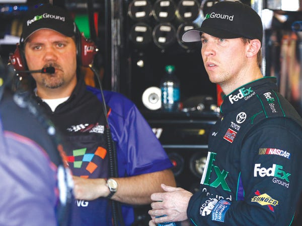 Denny Hamlin, right, meets with crew chief Darian Grubb in Avondale, Ariz., on March 2. (Ross D. Franklin | Associated Press)