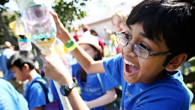 Praveen Anbu, 11, with the Middle School of the Arts, gets excited before his bottle rocket launch during the South Florida Science Musuems 27th annual Drop It, Build It, Fly It, Launch It - Thrill It Engineering Competition on March 9, 2013. (Richard Graulich/The Palm Beach Post)