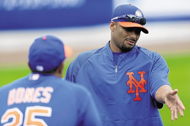 New York Mets starting pitcher Johan Santana, right, talks to bullpen coach Ricky Bones (25) before an exhibition spring training baseball game Detroit Tigers, Friday, March 1, 2013, in Port St. Lucie, Fla. (AP Photo/Julio Cortez)