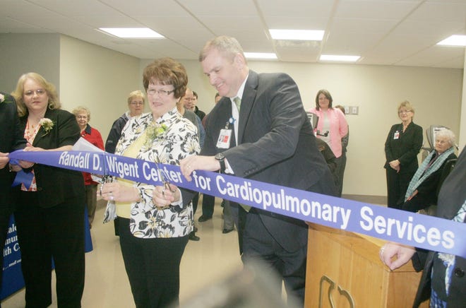 Esther Wigent, left, and Duke Anderson, right, cut the ribbon to the Randall D. Wigent Center for Cardiopulmonary Services at the Hillsdale Community Health Center. The unit was dedicated to Esther's husband Randall who was a patient in the ward for more than 20 years. MATT DURR PHOTO