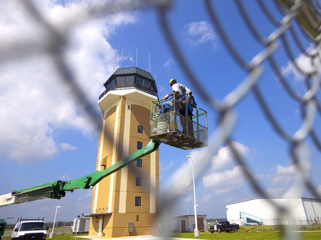 In this Sept. 29, 2009 file photo, a construction crew works on the control tower at the Ocala International Airport. Federal sequestration cuts are affecting operations at the airport.