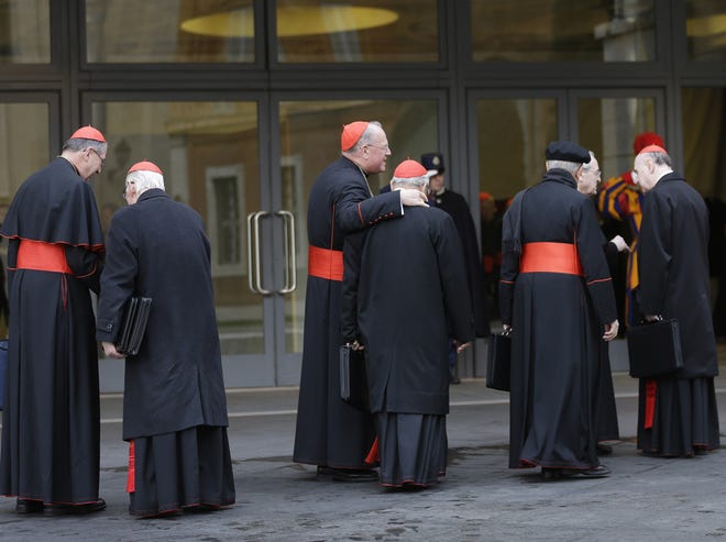 Cardinals, including U.S. Roger Mahony, left, and Timothy Dolan, third from left, arrive for a meeting at the Vatican, Monday March 11, 2013. Cardinals have gathered for their final day of talks before the conclave to elect the next pope amid debate over whether the Catholic Church needs a manager pope to clean up the Vatican's messy bureaucracy or a pastoral pope who can inspire the faithful and make Catholicism relevant again. (AP Photo/Alessandra Tarantino)