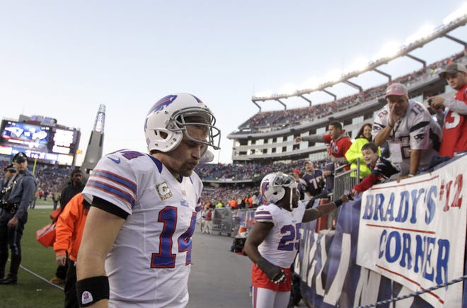 Buffalo Bills quarterback Ryan Fitzpatrick (14), left, steps off the field after the Bills 37-31 loss to the New England Patriots in an NFL football game at Gillette Stadium, in Foxborough, Mass., Sunday, Nov. 11, 2012. (AP Photo/Steven Senne)