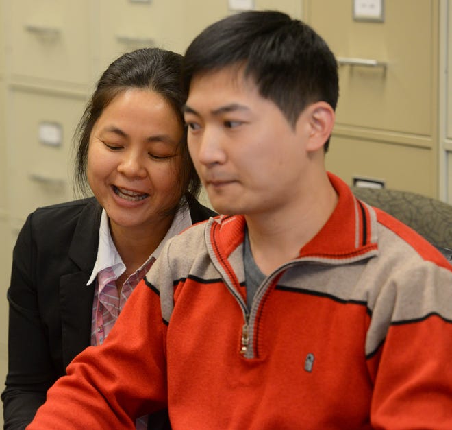 Mei Chen, left, a Chinese-speaking interpreter who is certified by Multicultural Association of Medical Interpreters (MAMI), speaks Chinese to Rome resident Zi Wu, right, during a Committee on Special Education (CSE) meeting with employees at the Rome City School District office about his son, Jason Wu, Tuesday, March 12, 2013. When asked why Chen decided to become a translator, she said she wants to help people and make people who don't speak English feel more comfortable when they face challenges such as asking for help.