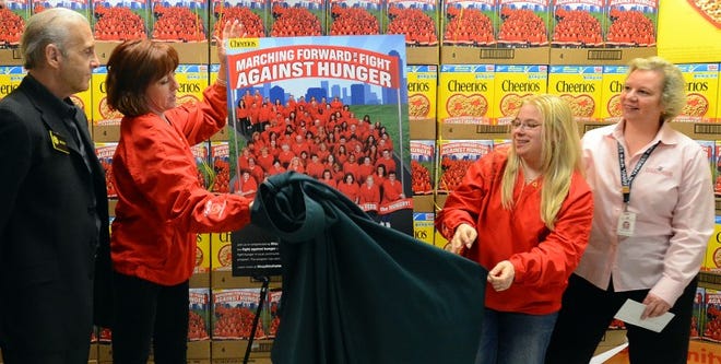 Taking part in the unveiling of the limited edition Cheerios box at the ShopRite in Marlton were (l) Ron Ravitz, owner of several ShopRite stores, cashiers Tricia Morris of Mount Holly and Victoria Huber of Cherry Hill, whose photos are on the box and Sabine Mehnert of the Food Bank of South Jersey.
