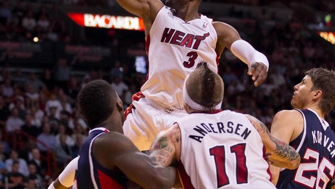 Dwyane Wade drives the basket in the fourth quarter at AmericanAirlines Arena.