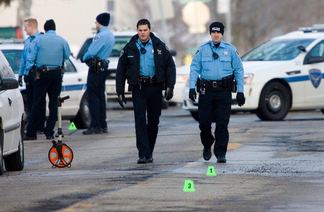 Rockford police officers work the scene of a shooting Saturday, Feb. 23, 2013, on Morgan and Sanford streets in Rockford.