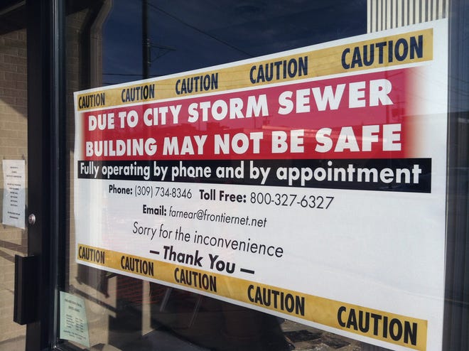 A sign at Far and Near Travel Agency, 223 S. First St., warns passerby of an ongoing sewer issue below the location.