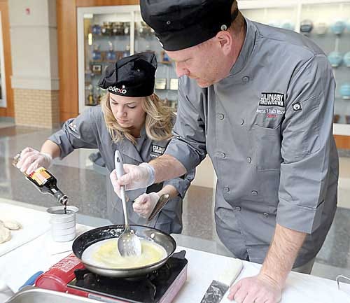 Photo by Lauren Scrudato/New Jersey Herald - Courtney Czapelski and Sparta High School Assistant Principal Steve Stoner mix up their concoctions at the Culinary Throwdown Competition.