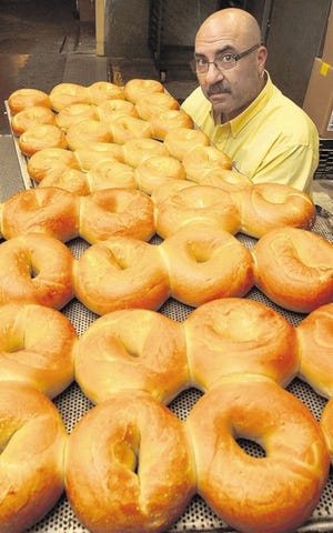 The Monticello Bagel Bakery makes an average of 25,000 bagels a week. Jeff Siegel, showing off the bounty of bagels on Friday, pushed for the designation of Monticello as “The Bagel Capital.”