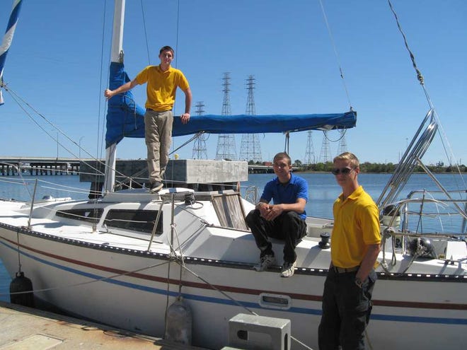 Safe Harbor residents Warren (from left), Jo and Keith hang out at one of the boats donated to the Jacksonville boys home and maritime academy. They said they had been getting into trouble before coming to Safe Harbor, but the program for at-risk boys got them on the "right track."