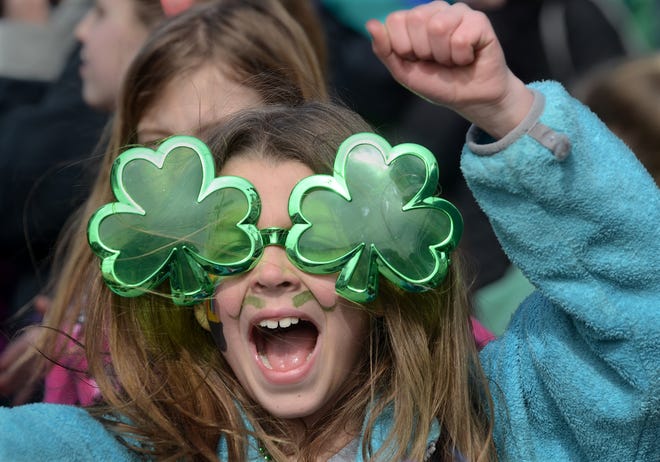 Tiara Hume, 9, of Marshfield cheers as the annual St. Patrick's Day Parade passes Sunday in downtown Scituate. Hundreds of people from around the region lined the 2.3-mile route to watch the annual parade.