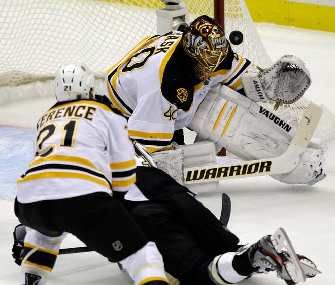 Bruins defenseman Andrew Ference checks Penguins center Joe Vitale as Vitale scores on goalie Tuukka Rask on Sunday.