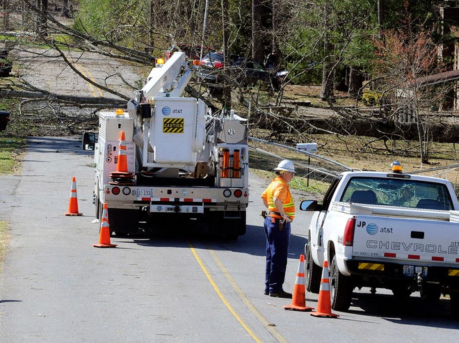 An AT&T crew gets to work on Williams Avenue Tuesday, March 18, 2013, in Rainbow City, Ala. A powerful storm caused widespread damage and power outages Monday afternoon. (Gadsden Times, Marc Golden)