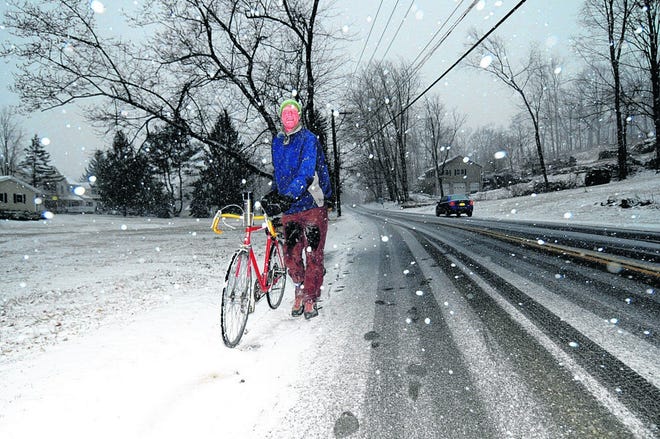 Ralph Wolckenbauer of Warwick ended up pushing his bicycle home down West Street Monday night as the snow piled up.