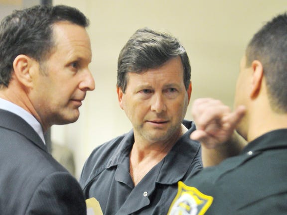Attorney Kelly Mathis, center, and his attorney, Mitch Stone, talk with a bailiff on March 14, 2013 in Sanford, Fla., after Mathis's bail was set at $1 million for his role in the Allied Veterans of America investigation.