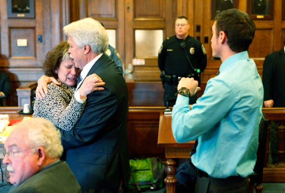 Mark Strong Sr. comforts his wife, Julie, after she became emotional while addressing Justice Nancy Mills during Strong's sentencing at Cumberland County Superior Court in Portland on Thursday.