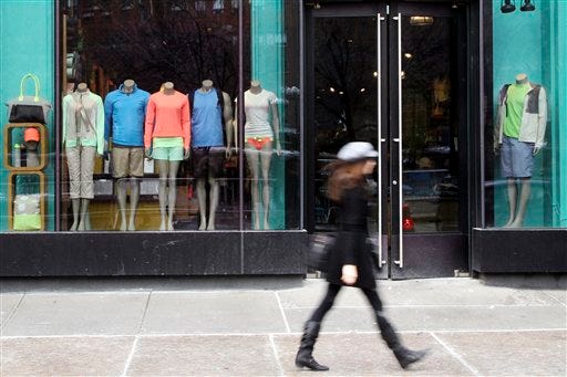 A pedestrian walks past the Lululemon Athletica store Tuesday at Union Square in New York. Lululemon has yanked its popular black yoga pants from store shelves after it found that the sheer material used was revealing too much of its loyal customers. (AP Photo/Mary Altaffer)
