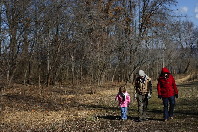 Five year-old Ava Summers, Zach Bright and Katelynn Essig look for signs of spring at Lincoln Memorial Garden during the Nature Story Adventure "A New Beginning: Celebrating the Spring Equinox" Thursday. Despite the arrival of spring, temperatures hovered in the 20?s for the trio?'s nature hike. Ted Schurter/The State Journal-Register