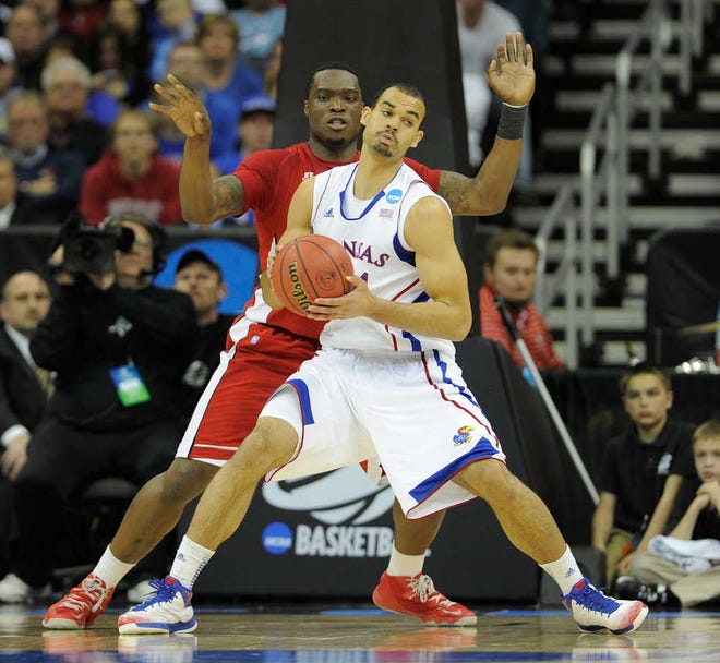 Forward Perry Ellis works against Kene Anyigbo of Western Kentucky Friday at the Sprint Center. Ellis came off the bench Ellis to give the Jayhawks nine points and seven rebounds, coming up one point shy of his third straight double-figure scoring game, in the hard-fought 64-57 win Friday over the Hilltoppers.