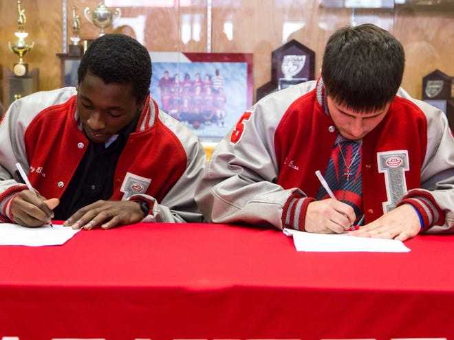 Rodney Brown, left, and J.R. Bass sign on to play football at Webber International on Friday at Lafayette High in Mayo. (Photo by Jack Howdeshell)