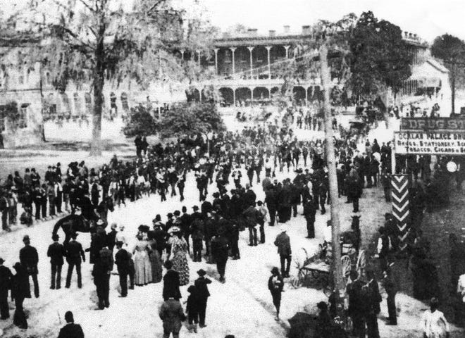 People line both sides of East Broadway to witness a typical Fourth of July parade in Ocala in the 1890s and early 1900s. The Ocala House Hotel is shown in the background. (File photo)