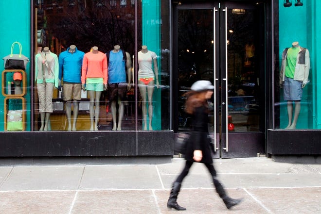 A pedestrian walks past the Lululemon Athletica store at Union Square in New York. Lululemon has yanked its popular black yoga pants from store shelves. (The Associated Press)