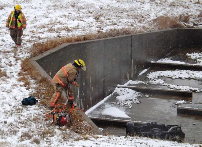 Crews work a scene Saturday afternoon in which a person was fatally wounded in a rollover wreck that ended with the vehicle upside down in a culvert along Interstate 470 on the Kansas Turnpike.