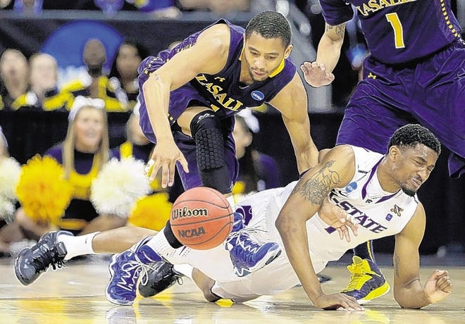 La Salle guard D.J. Peterson, left, beats Kansas State guard Shane Southwell to a loose ball during the second half of a second-round game of the NCAA college basketball tournament on Friday, March 22, 2013, in Kansas City, Mo. La Salle won the game 63-61. (AP Photo/Charlie Riedel)