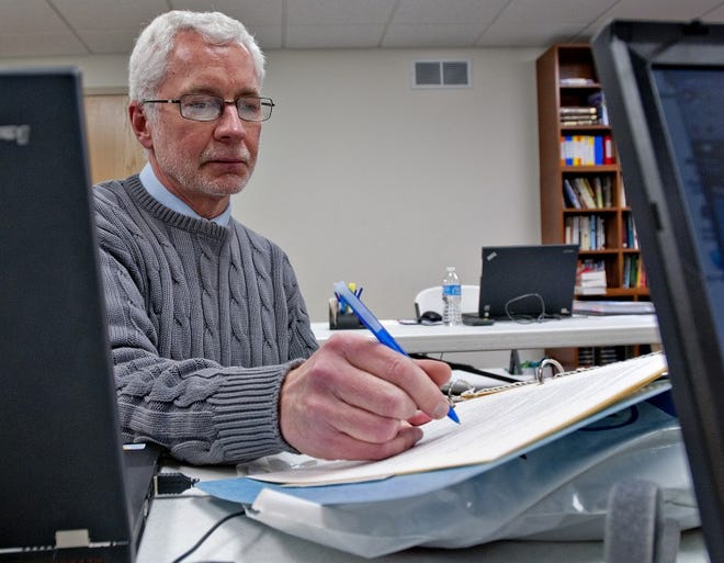 Jim Spiegle, a volunteer tax-preparer, looks over notes while getting ready to prepare taxes for individuals at St. Andrews United Methodist Church. The program offers free tax filing for those who make less than $57,000 a year.