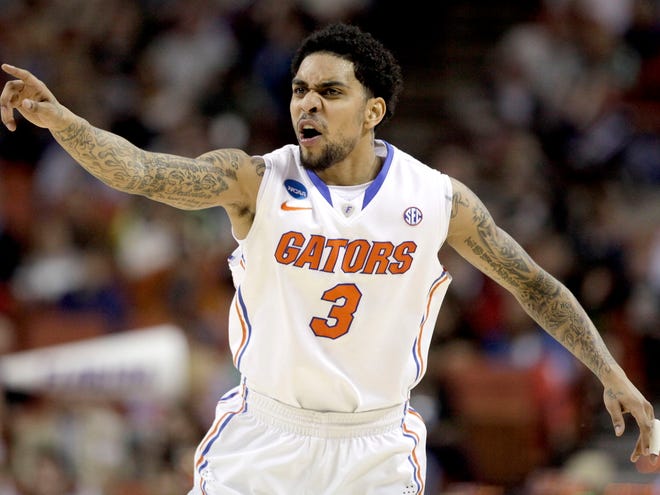 Florida Gators guard Mike Rosario signals to a teammate after making a three point shot against the Minnesota Golden Gophers during the third round of the NCAA tournament at the Frank Erwin Center on Sunday in Austin, Texas.