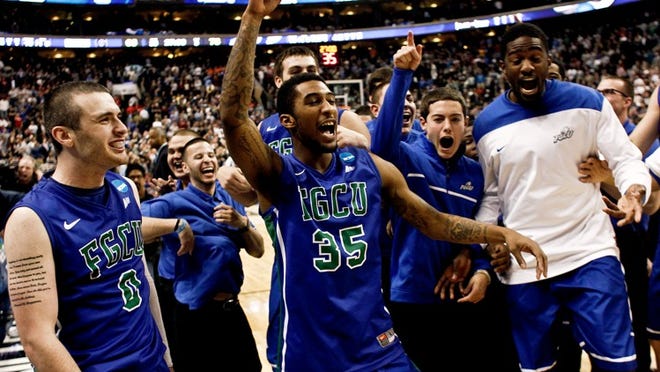 In this Friday, March 22, 2013, photo, Florida Gulf Coast's Brett Comer (0), Dajuan Graf (35) and others celebrate their 78-68 win over Georgetown in a second-round game in the NCAA college basketball tournament in Philadelphia. (AP Photo/Naples Daily News, Scott McIntyre) FORT MYERS OUT