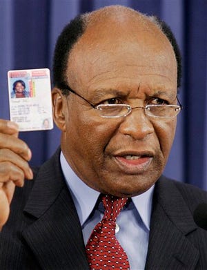 In this Oct. 23, 2007 file photo, Illinois Secretary of State Jesse White shows the newly redesigned Illinois drivers license during a news conference at the Illinois State Capitol in Springfield. White announced at the Illinois State Fair that he'll run for a fifth term in 2014, reversing his earlier position that this term would be his last. (AP Photo/Seth Perlman, File)