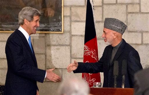 Secretary of State John Kerry reaches to shakes hands with Afghan President Hamid Karzai Monday at the end of their joint news conference at the Presidential Palace in Kabul. Kerry and Karzai made a show of unity Monday, shortly after the U.S. military ceded control of its last detention facility in Afghanistan, ending a longstanding irritant in relations between the two countries. Kerry, in Afghanistan for an unannounced visit, said he and Karzai were "on the same page" when it comes to peace talks with the Taliban.