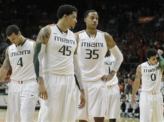 Miami's Trey McKinney Jones (4), Julian Gamble (45), Kenny Kadji (35) and Shane Larkin (0) walk back onto the court after a time-out with 29 seconds remaining in second half of an NCAA college basketball game against Georgia Tech in Coral Gables, Fla., Wednesday, March 6, 2013. Georgia Tech won 71-69.
