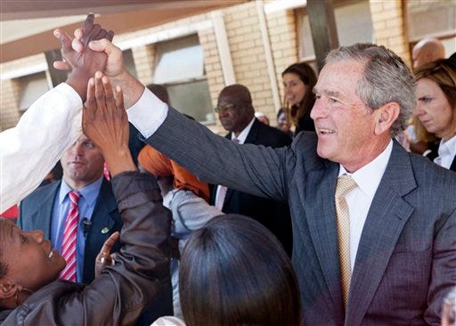 FILE - In this July 5, 2012 file photo provided by the George W. Bush Presidential Center, former President George W. Bush and his wife, Laura Bush stop to talk with people who have lined the hallways of the Princess Marina Hospital in Gaborone, Botswana. The government spent nearly $3.7 million on former presidents in 2012, according to an analysis just released by the nonpartisan Congressional Research Service. That covers a pension, compensation and benefits for office staff, and other costs like travel, office space and postage. The costliest former president? George W. Bush, who clocked in last year at just over $1.3 million. (AP Photo/George W. Bush Presidential Center, Shealah Craighead, File)