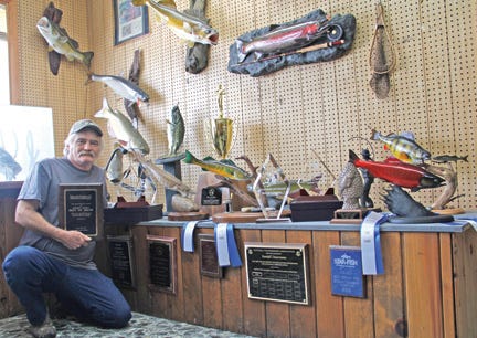 Randall Desormeau, owner and operator of Northland Taxidermy, poses with his awards after a successful visit to the Ultimate Sport Show in Grand Rapids. The official tally included four first place ribbons, three second place ribbons, state championships in reproduction and skin (real) as well as The Best of Show for his reproduction of a small sturgeon.