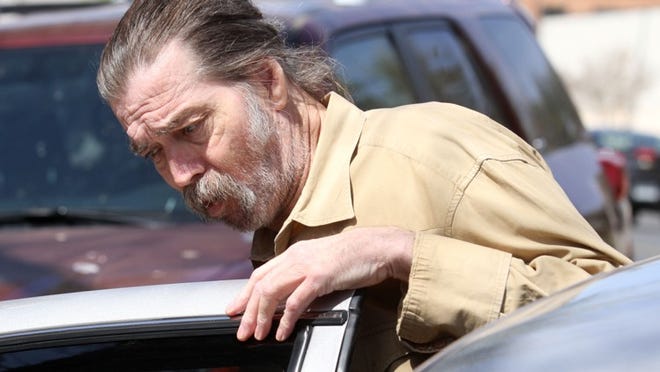 Mark Norwood climbs into the back of a Tom Green County sheriff's car Wednesday, March 27, 2013, in San Angelo after being found guilty of the 1986 murder of Christine Morton. Norwood was sentenced to life in prison.