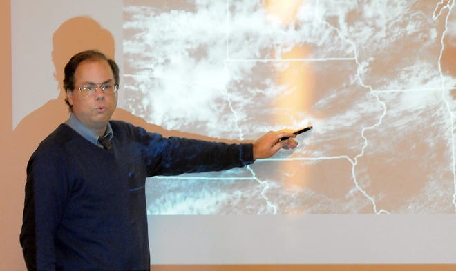 National Weather Service meteorologist Bill Babcock points to a thunderstorm forming in Iowa during a Skywarn informational session on how to spot storms, Tuesday in Franklin.