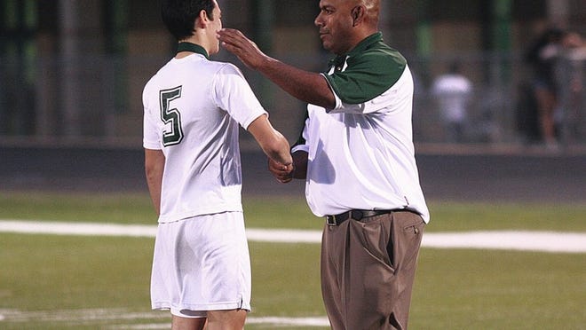 Connally seniors were recognized before the March 19 game between the Cougars and Georgetown. Pictured: Connally Principal Daniel Garcia shakes hands with senior Andy Fortin after presenting Fortin with a medal.
