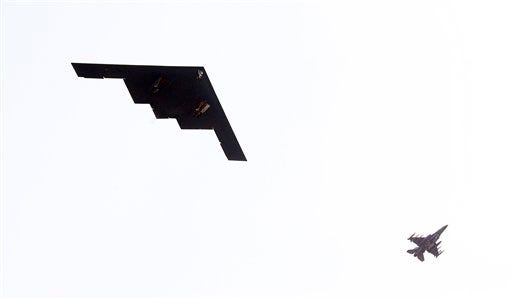 U.S. Air Force B-2 stealth bomber, left, flies over near Osan U.S. Air Base in Pyeongtaek, south of Seoul, South Korea, Thursday, March 28, 2013. A day after shutting down a key military hotline, Pyongyang instead used indirect communications with Seoul to allow South Koreans to cross the heavily armed border and work at a factory complex that is the last major symbol of inter-Korean cooperation. (AP Photo/Lee Jung-hun, Yonhap)