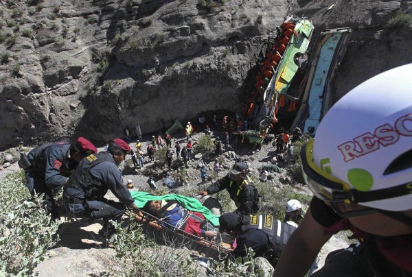 Police officers in Peru lift an injured passenger out of a ravine after a deadly crash near the city of Arequipa. Authorities said at least 24 people died and 18 were injured when the bus fell more than 300 feet down the ravine yesterday.