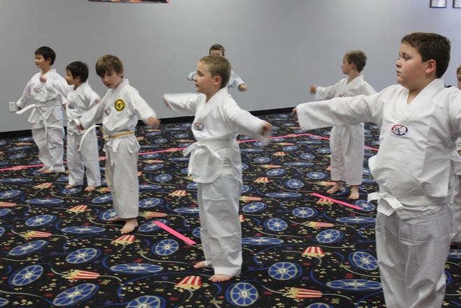 Children do warm-up exercises in class before training at Black Dragon Martial Arts in Prairieville. Instructor Ken Ducote says one hour of Taekwondo can burn up to 700 calories. More photos, videos and related blogs are on our website.