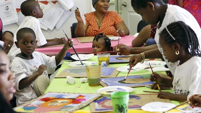Children and their parents painted self-portraits Tuesday afternoon at Bridges at Lake Park. The portraits will be part of an exhibit scheduled for summer 2013 at Studio E Gallery in Palm Beach Gardens.(Bill Ingram/The Palm Beach Post)