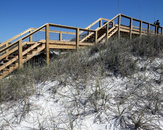 David Demarest takes a photo atop the new surfer’s boardwalk at St. Andrews State Park in Panama City Beach on Thursday.
